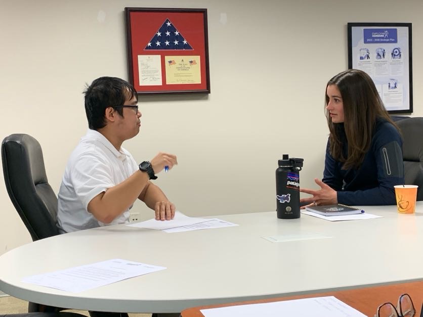 Harold Atienza (left) answers interview questions from Amanda Jacobs (right), an HR and Controls Specialists at Sordoni Construction.