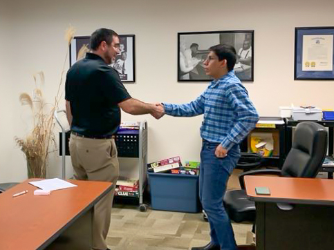 Tim Lorenzo (left), Director of Human Resources at Sodoni Construction, shakes hands with David Sinchi (right) before their mock interview.